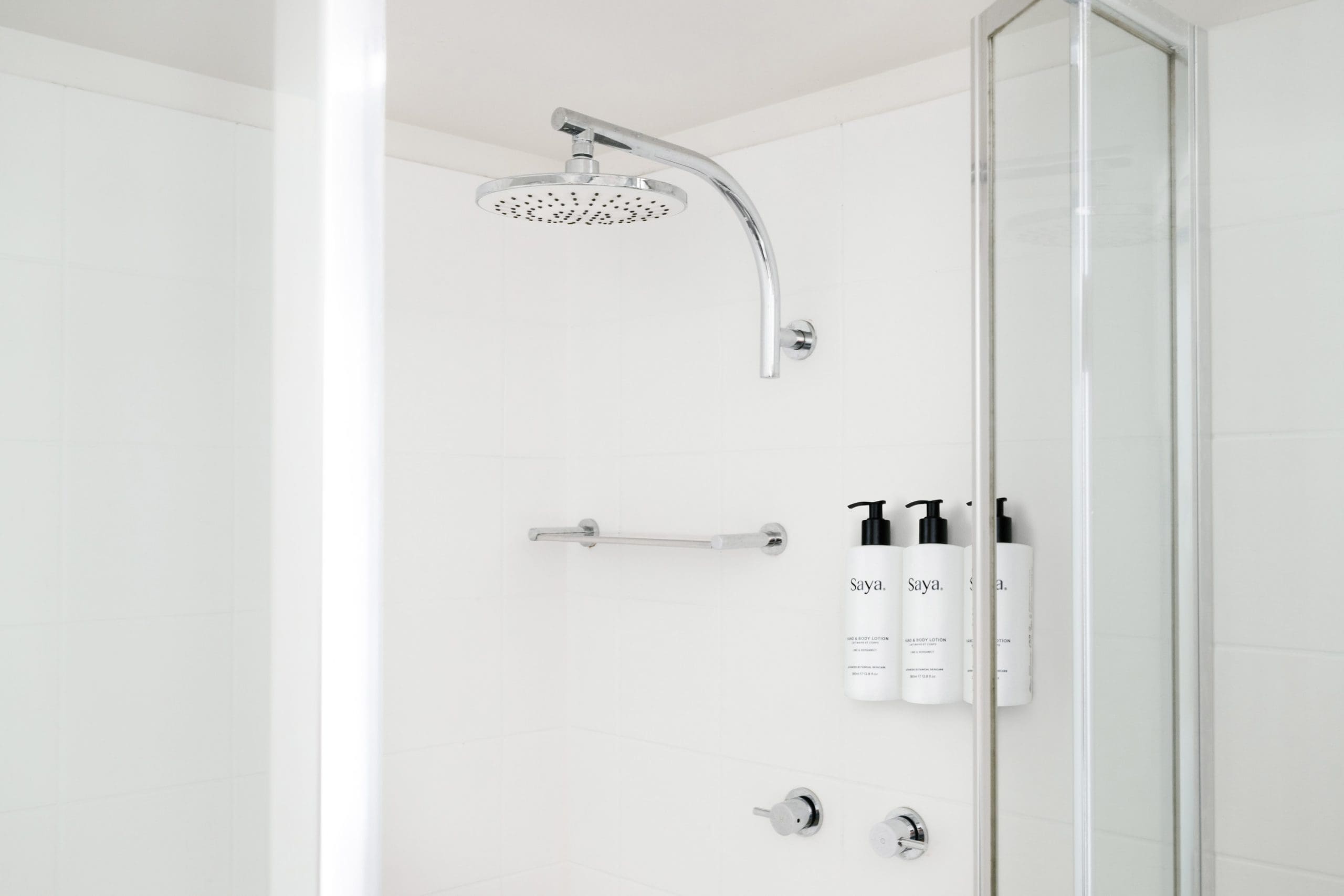 The Leea Darwin hotel shower features a rainfall showerhead and wall-mounted Saya toiletries.